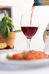 Pouring Red Wine with Italian Cuisine