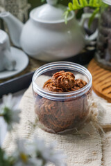 A bottle of dark colored cookies.  Coffee Cookies.  Biskut Kopi.