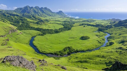 Obraz premium Lush green valley, meandering river, ocean view, island landscape