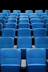 Naklejka premium Empty rows of blue cinema seats in a dark theater setting.