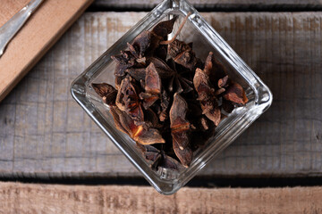 Top view of a jar with anise stars or anise flowers.