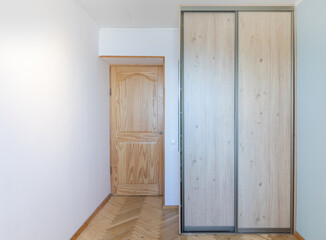 Minimalist Interior with Wooden Door and Modern Sliding Wardrobe. Home Living Room or Bedroom Interior