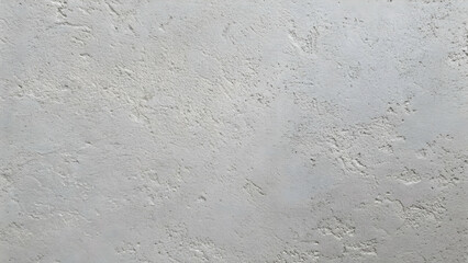 Obraz premium Textured Concrete Wall: A close-up shot reveals the intricate texture of a light gray concrete wall, showcasing a rough, uneven surface with subtle variations in tone and depth.