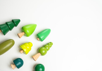 Arranged tree figures and white background for text. Freshness and spring motif. Eco-friendliness and naturalness. Environmental awareness, green energy, and organic lifestyles.