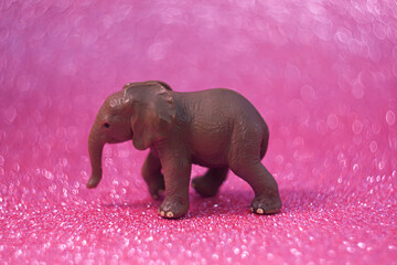 Miniature Elephant Figure on Sparkling Background. Soft focus.