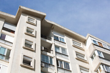 Obraz premium Modern residential building exterior with balconies and windows against blue sky in Bar, Montenegro