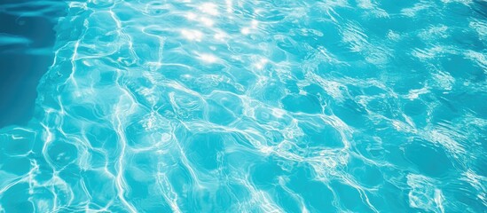 Obraz premium Serene blue swimming pool water reflecting sunlight under a clear sky evoking relaxation and tranquility with space for text or branding