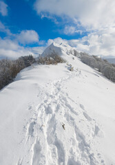 Campo Felice, Italy - The suggestive plateau peak in Abruzzo region, Monte Puzzillo and Morretano summit mount range, during the winter with snow and alpinists in altitude