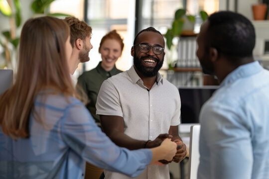 Joyful man engaged in a conversation with colleagues in a bright setting