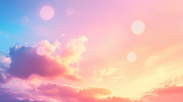 Blurred sunset sky with colorful clouds creating an abstract bokeh background featuring blue, pink, and yellow circular light patterns