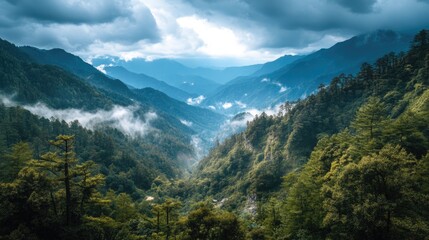 Obraz premium Majestic Mountains and Lush Green Valley Under Dramatic Cloudy Sky in Scenic Natural Landscape View