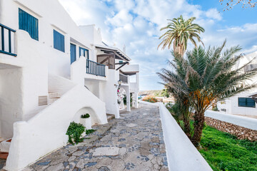 A quiet, whitewashed alley in Binibeca Vell, Menorca, showcasing authentic Balearic architecture...
