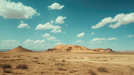 Fototapeta premium Desolate Desert Landscape with Pyramids under Clear Blue Sky and Fluffy Clouds