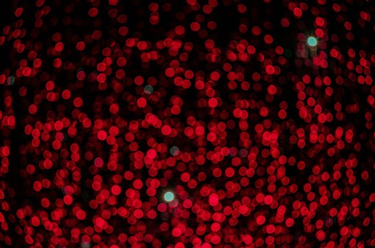 red flashlight stars (blur) on a black background