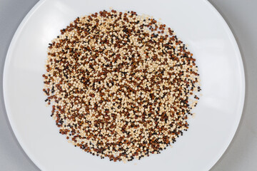 Raw black, red and white quinoa seeds mix, top view