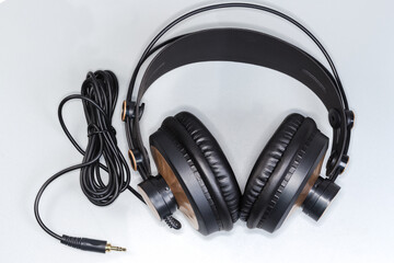 Wired full size headphones on a gray background, top view