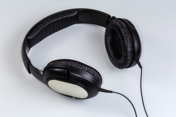 Wired full size headphones on a gray background