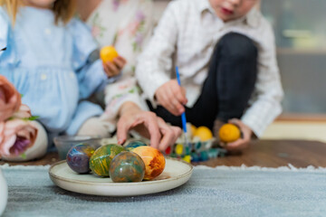 A boy and a girl paint Easter eggs with colorful paints. Easter concept, leisure, children