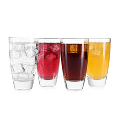 Soda water of different flavors with ice cubes in glasses isolated on white
