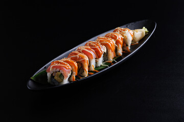 Salmon Sushi roll with crab stick and cucumber Sushi menu Japanese food isolate in black background.