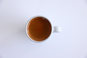 Espresso coffee with white cup on wooden table and Hand holding a white cup of hot espresso coffee