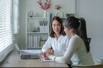 Asian Bussiness woman using laptop consult business finance strategy.