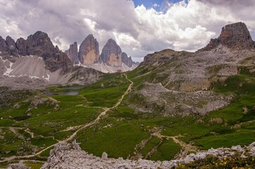 Hiking trail in the Italian Dolomites. Stunning view of the Three Peaks of Lavaredo (Tre cime di Lavaredo) during a beautiful day. Drei Zinnen of Lavaredo are the undisputed symbol of the Dolomites.