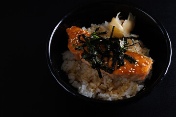 salmon teriyaki suace japanese food isolate in black background