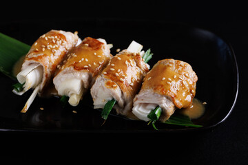 japanese pork roll grill japanese food isolate in black background