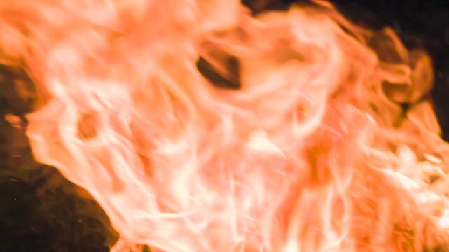 Explosive Gasoline Fire in Dark. Bright and vivid bursts of flame captured in close-up, appearing dynamically against a deep black background. Perfect for use in visual effects, action scenes, or dram