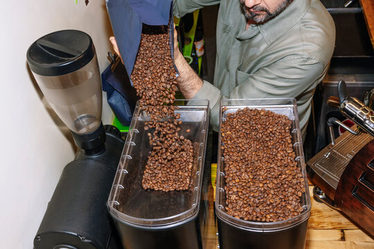 Specialty coffee beans being poured into storage containers