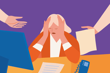 An overwhelmed and stressed worker at her desk