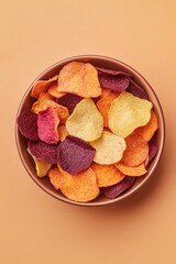 top-down view of snack bowl filled with colorful vegetable chips made from sweet potato beetroot and parsnip bright