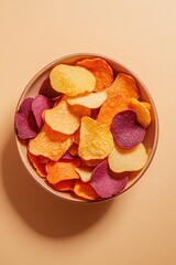 top-down view of snack bowl filled with colorful vegetable chips made from sweet potato beetroot and parsnip bright