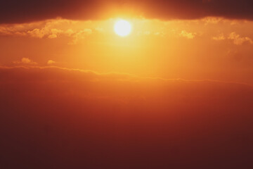 Stunning Golden Sunset with Dramatic Clouds Creating a Warm and Serene Atmosphere in the Evening Sky