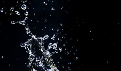 ** Dynamic Splash of Water Droplets Against a Dark Background Capturing Motion and Fluidity in High-Speed Photography..**