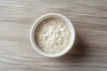 Plain oatmeal on wooden background.