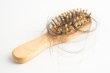 Hair loss fall with comb brush isolated on white background.