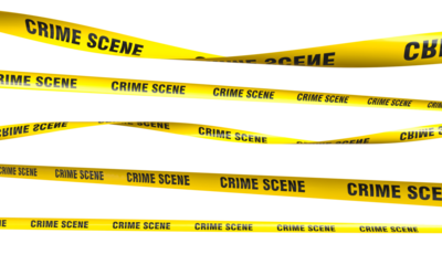 Yellow crime scene tape waving and restricting access