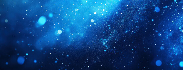 Obraz premium Abstract blue background with sparkling particles and bokeh effects. Cosmic, magical and festive feel, motion blur. Selective focus.