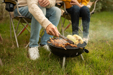 Enjoying a Sunny Afternoon as Friends Gather for a Barbecue in a Backyard Setting