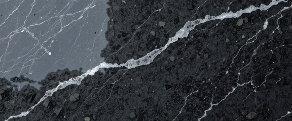 Obraz premium Close-up of a textured black surface with white veins.