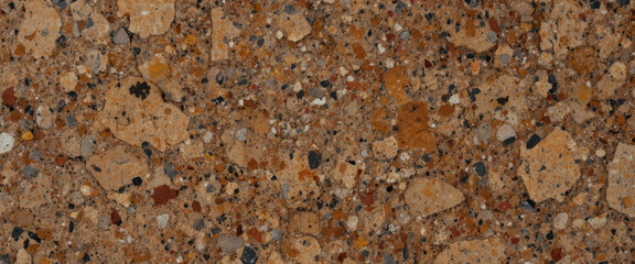 Close-up of textured brown stone surface with various mineral fragments.