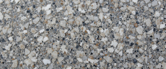 Close-up of a textured concrete surface with aggregate stones.