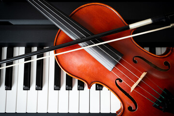 Violin on top of piano keyboard background