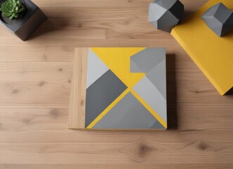 Geometric shapes in yellow and gray square brochure layout on wooden desk, gray, office