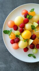 Delicious Summer Fruit Salad: A Refreshing Mix of Melon Balls, Raspberries, and Citrus