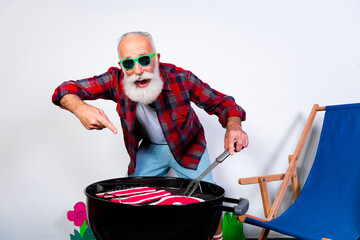 Elderly man enjoying a backyard barbecue with fun decorations and summer vibes