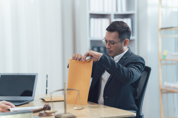 Lawyer Opening Envelope: A focused lawyer, dressed in a sharp suit, sits at his desk, carefully opening a brown envelope. The scales of justice and a gavel are visible in the background.
