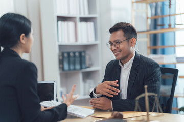 Legal Consultation: A professional lawyer, clad in a crisp suit, engages in a productive consultation with a client, reflecting a scene of legal expertise, trust, and problem-solving. 